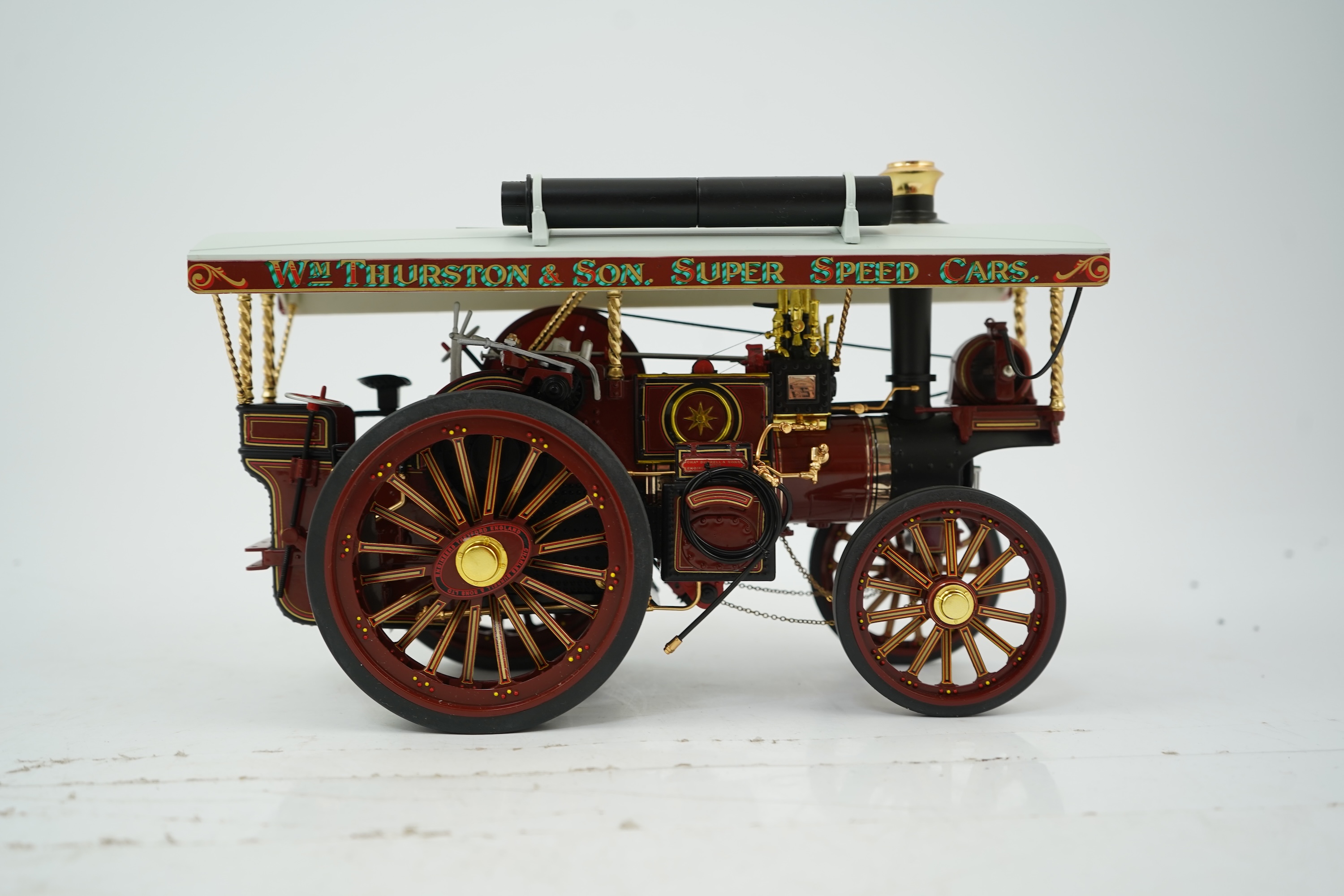 A Midsummer Models Ltd. 1:24 scale model of a Burrell Showman’s Engine, Britannia, in William Thurston and Son. Super Speed Cars livery, missing the original card box, but with an oak and Perspex display case